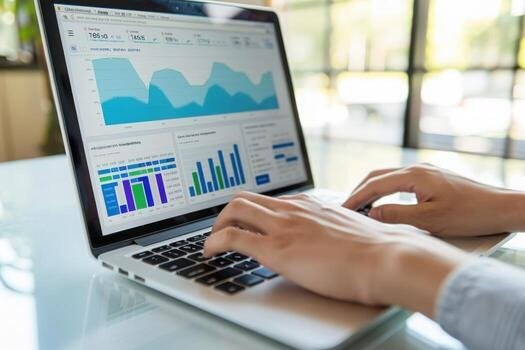 Person analyzing marketing performance data on a laptop with charts and analytics dashboard.